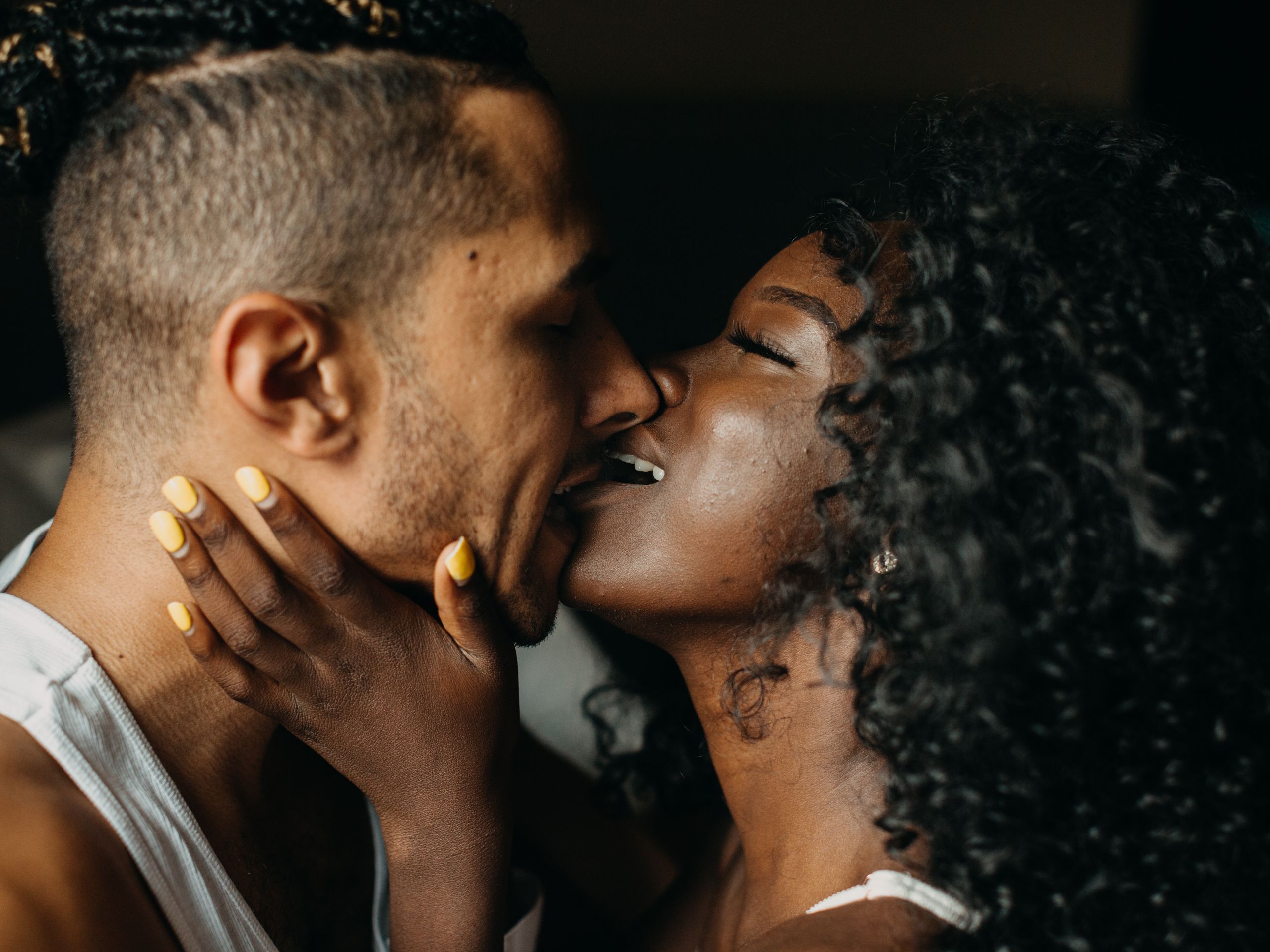 profile of faces of black couple kissing